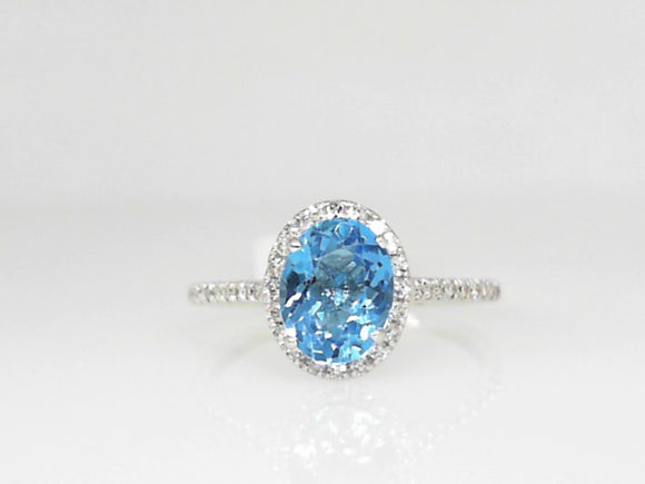 White Gold Oval Blue Topaz ring with 0.20 CT Diamond Halo