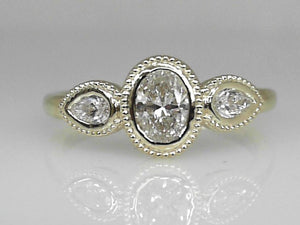 Yellow Gold Oval and Pear Diamond Bezel Set Ring