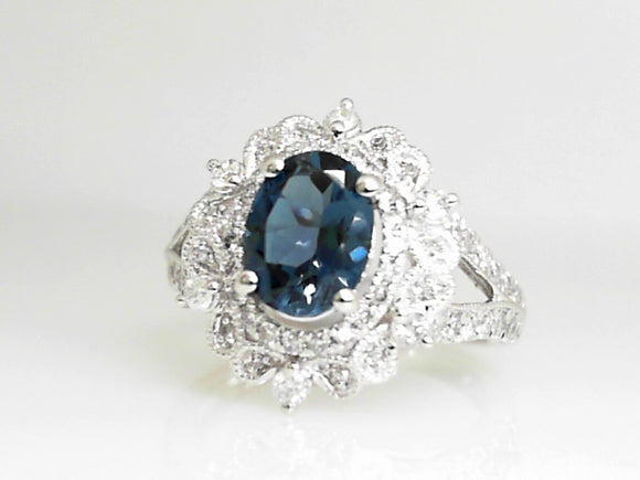 White Gold Oval Blue Topaz Ring with a Double Diamond Halo and Split Shank